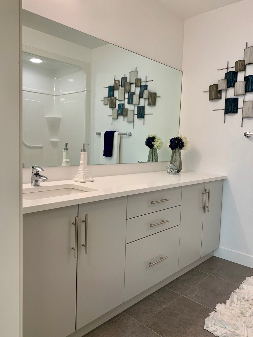 a white bathroom with a sink and a mirror