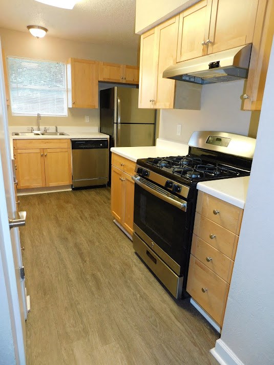 a kitchen with a stove and a refrigerator