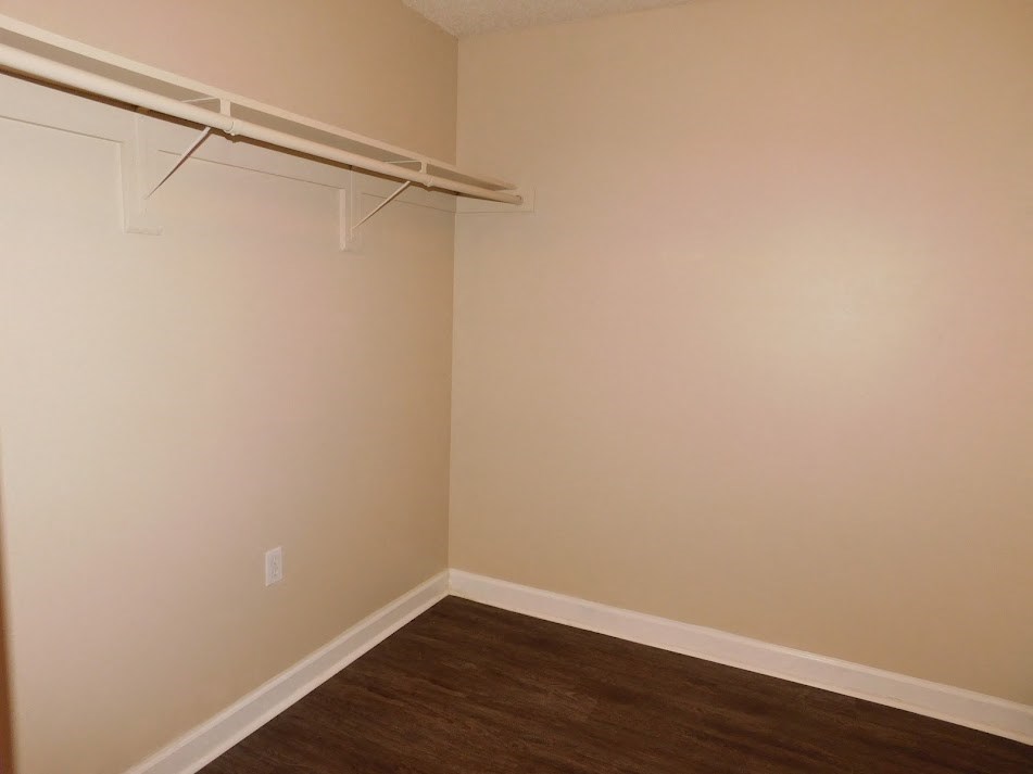 a room with a closet and a wooden floor