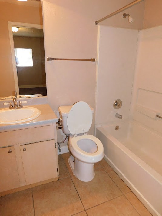a bathroom with a toilet and a sink and a shower