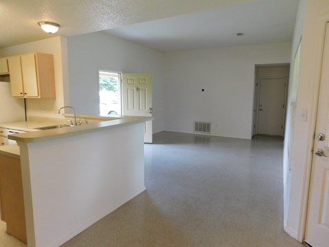 an empty kitchen and living room with an empty floor