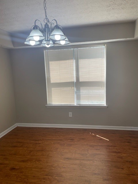 a living room with a large window and a wooden floor