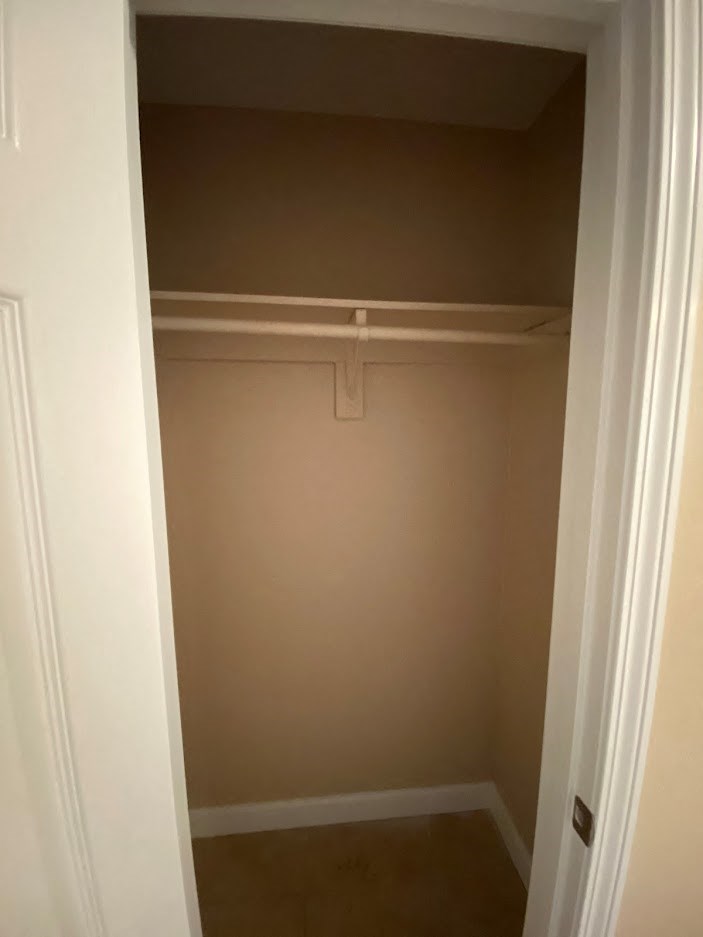 a empty closet with a clothes rack in it