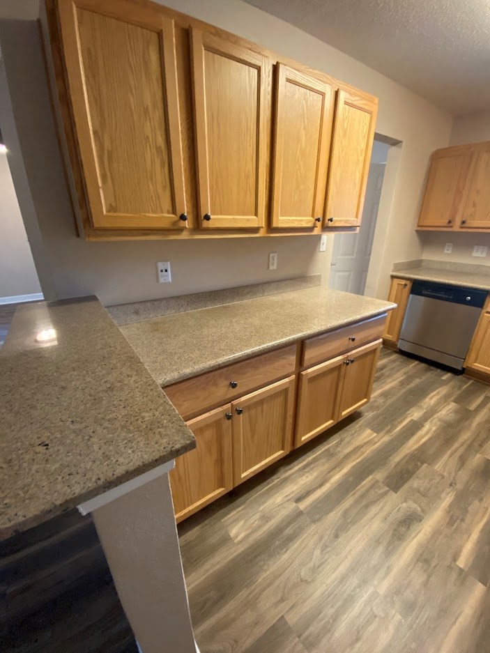 a kitchen with wooden cabinets and a counter top