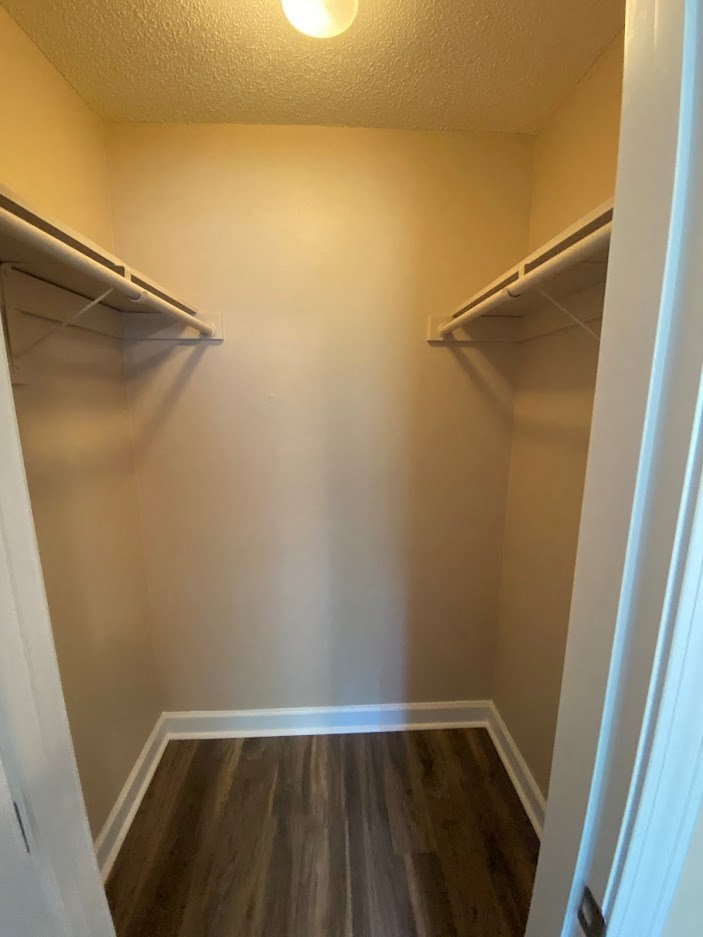 a walk in closet with two empty shelves