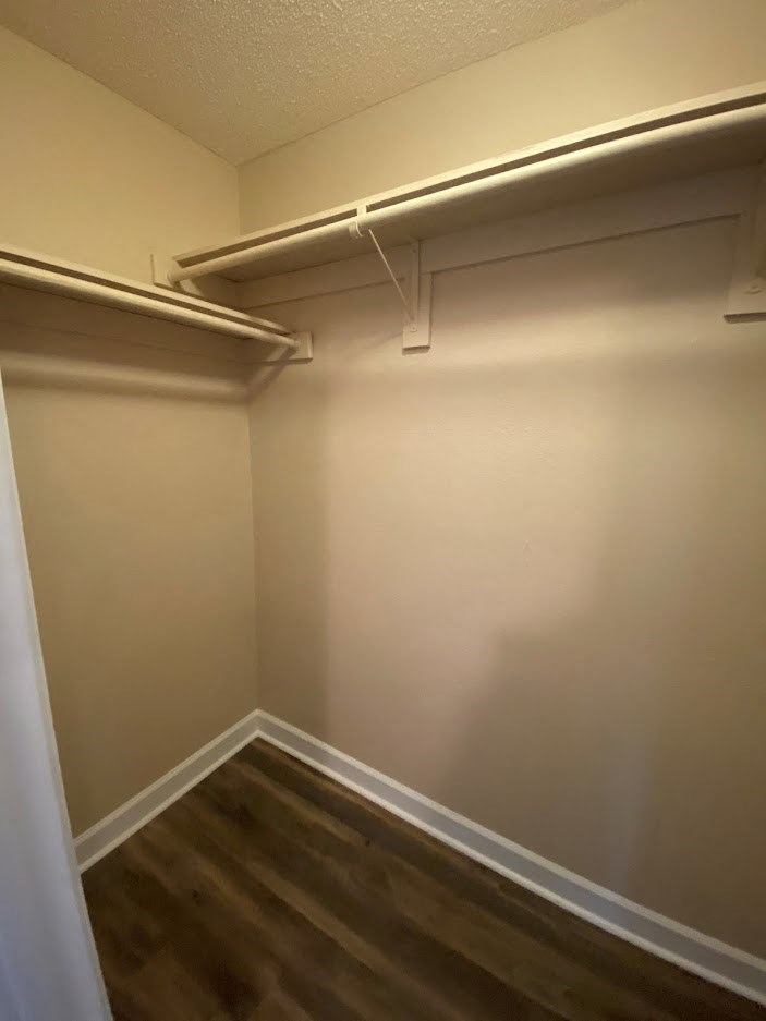 a large empty closet in a room with wooden floors