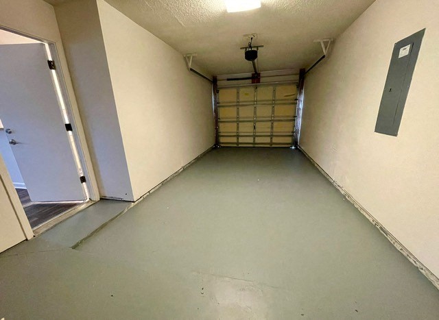 a long hallway with a door to a garage