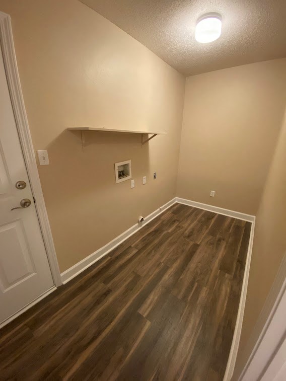 a empty room with wooden floors and a white door