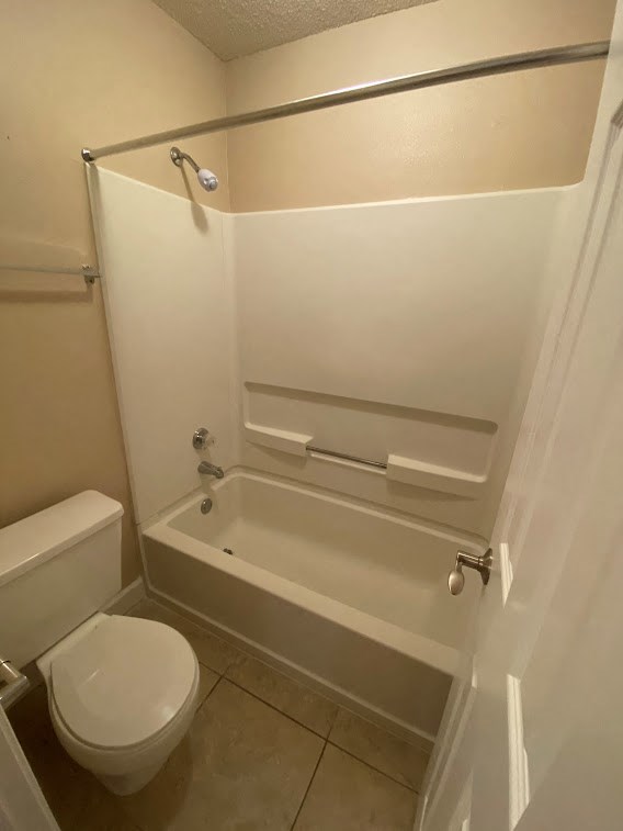 a bathroom with a toilet and a bath tub