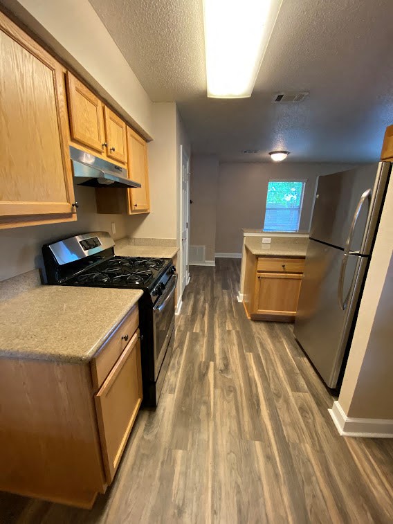 a kitchen with a stove and a refrigerator