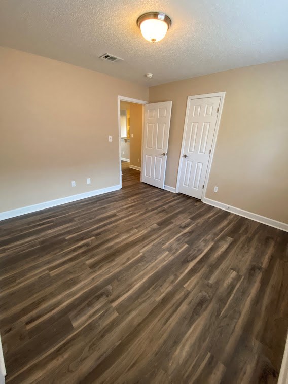 an empty living room with wood flooring in a home
