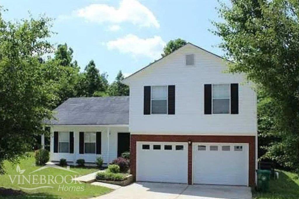 a white house with two garage doors