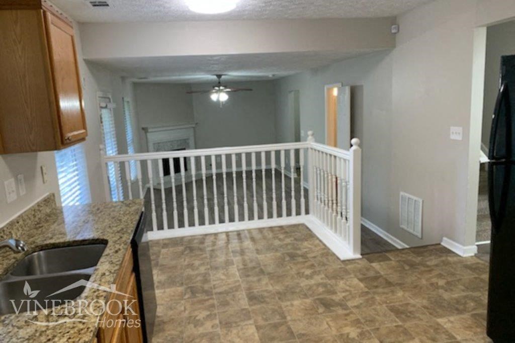 a kitchen with a white railing and a counter top