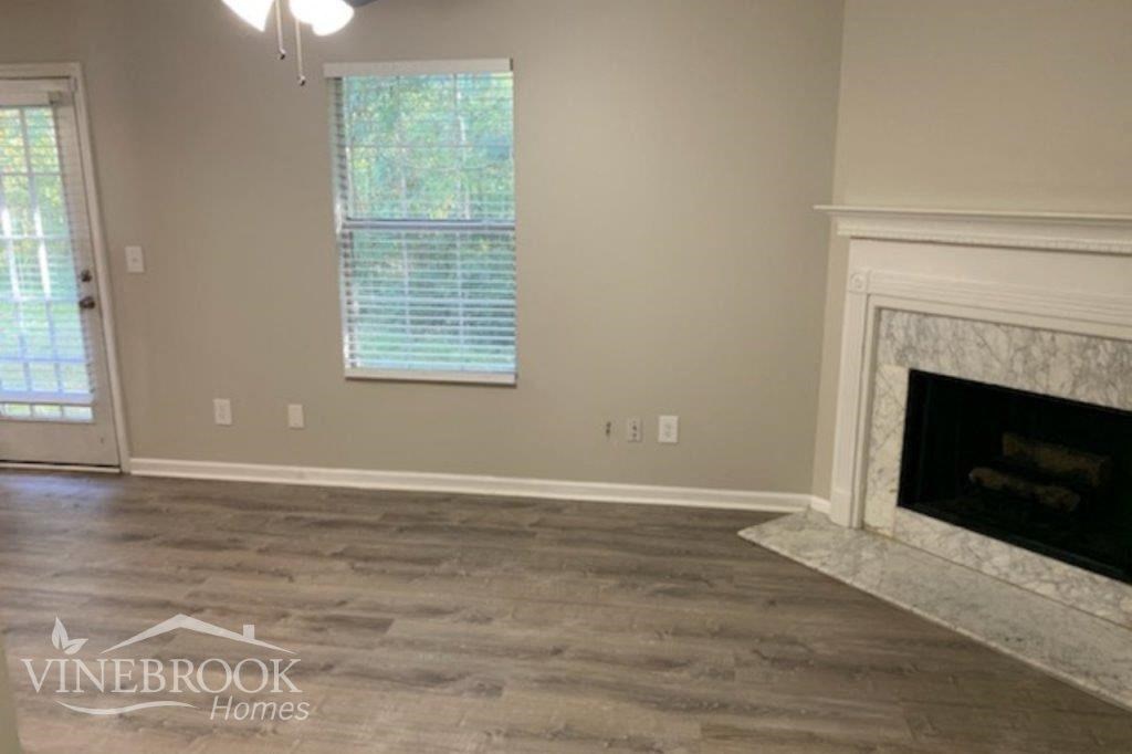 a living room with wood floors and a fireplace