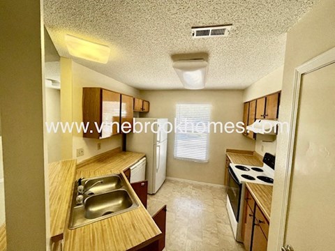 a kitchen with wooden counter tops and a sink