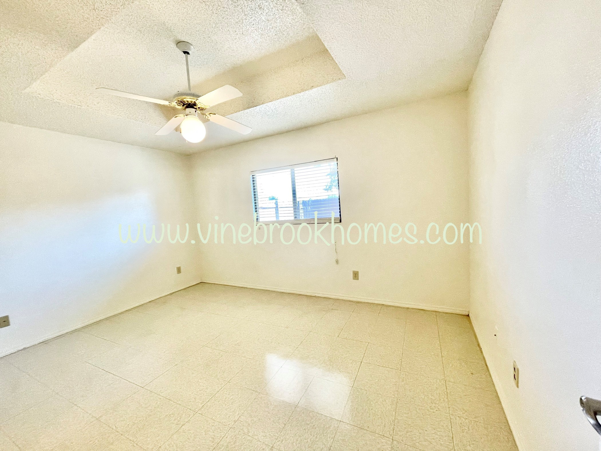 two bedroom apartment living room with a large closet and a ceiling fan