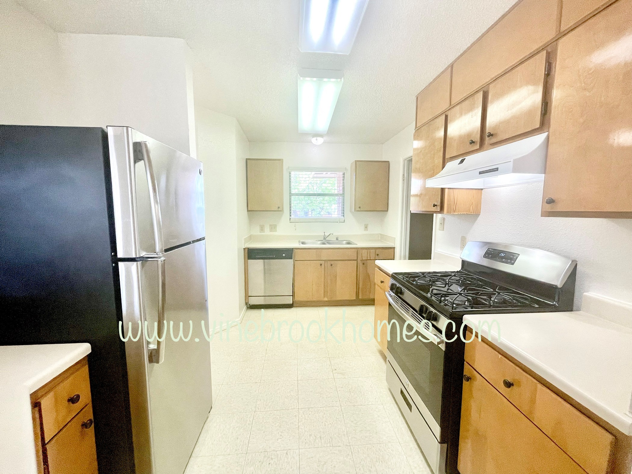 a kitchen with a stove and a refrigerator