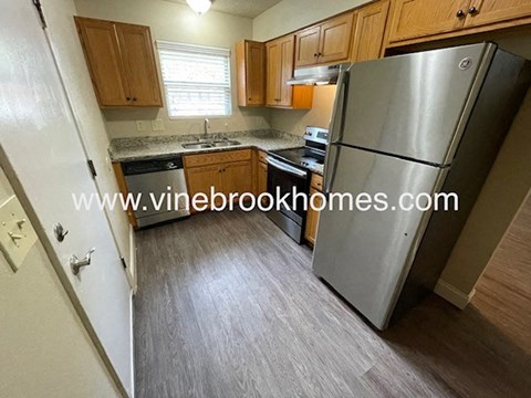 a kitchen with stainless steel appliances and wooden cabinets