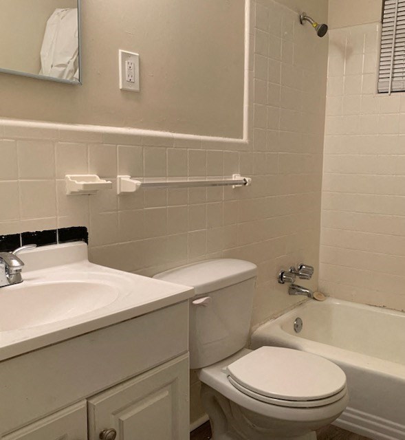 a bathroom with a toilet and a sink and a bath tub