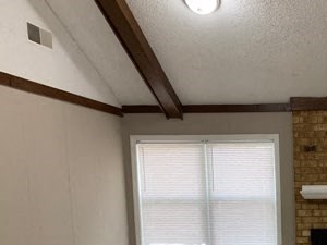 A room with a fireplace and a door.