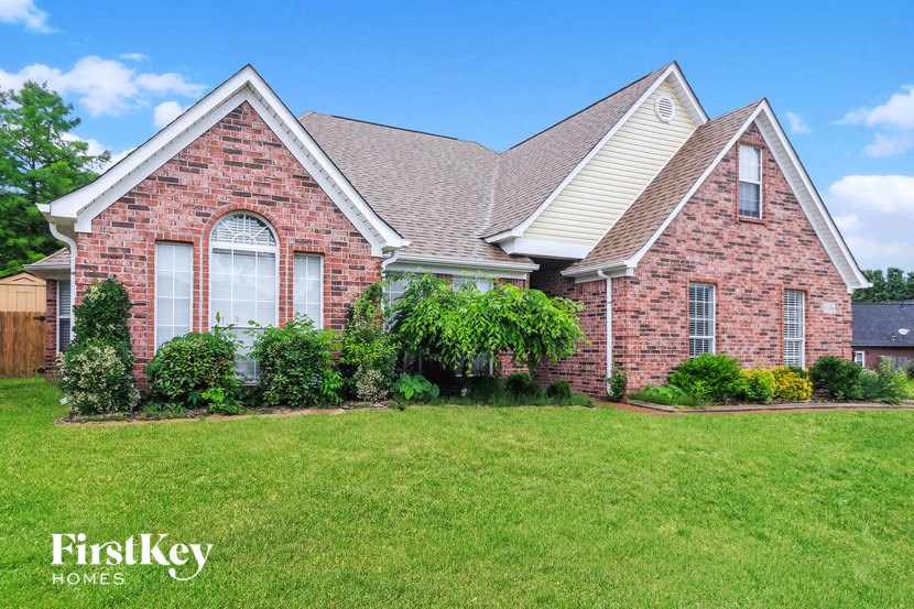 a brick house with a lawn in front of it