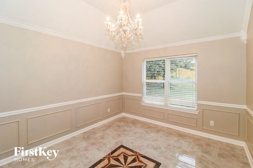 a dining room with a chandelier and a window