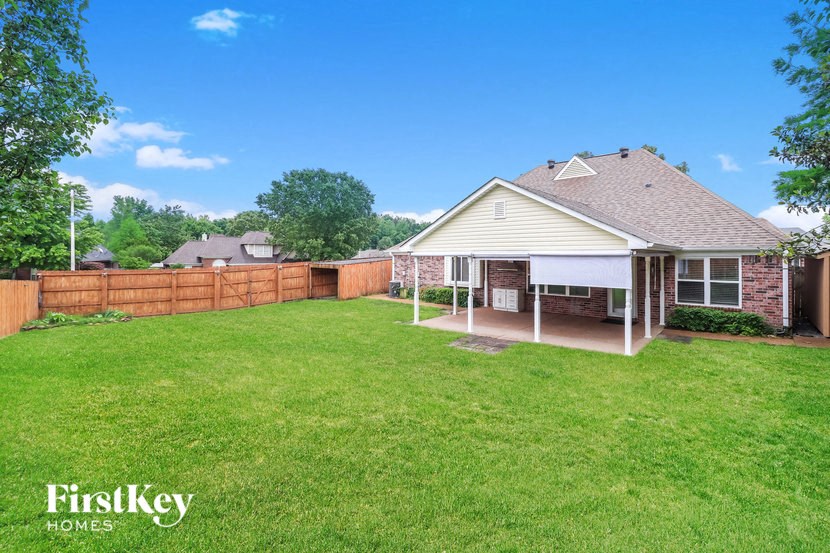 a backyard with a fence and a house