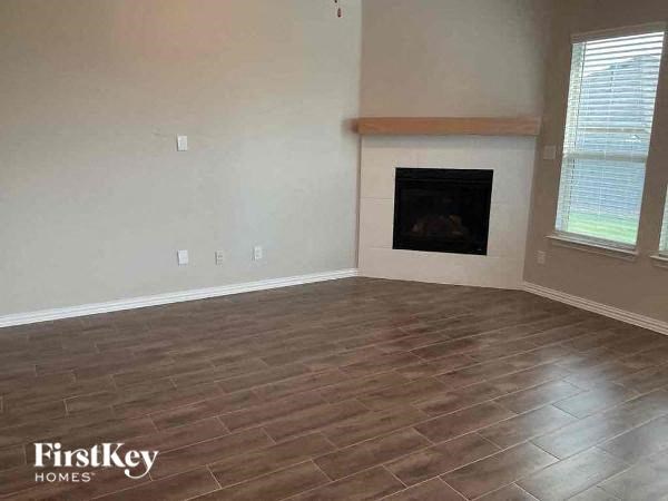 a living room with a fireplace and a wooden floor