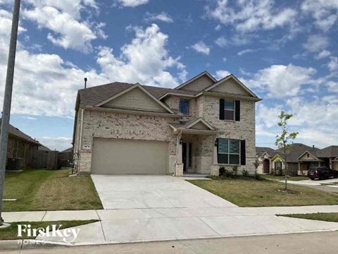 a house with a driveway and a garage door