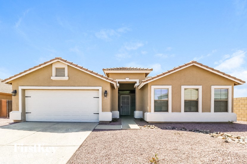 A house with a white garage door and a brown roof.