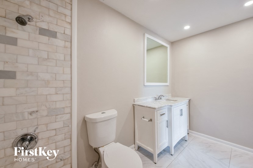a white bathroom with a toilet and a sink