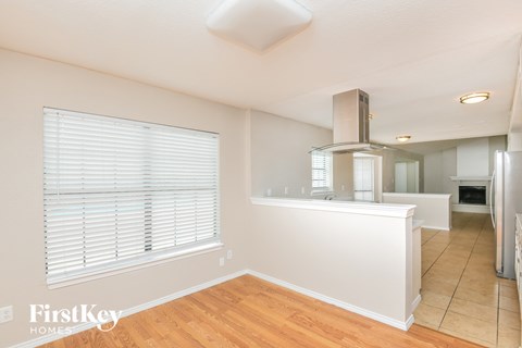 A kitchen area with a stove and a refrigerator.