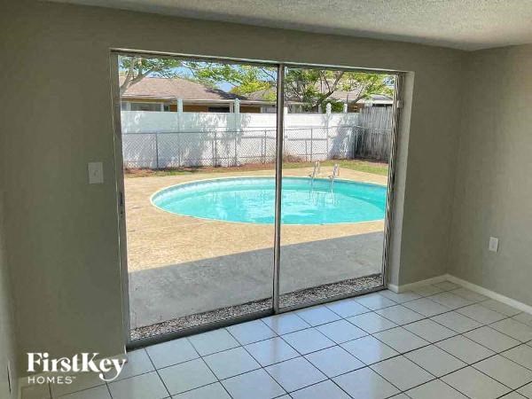A room with a pool outside.