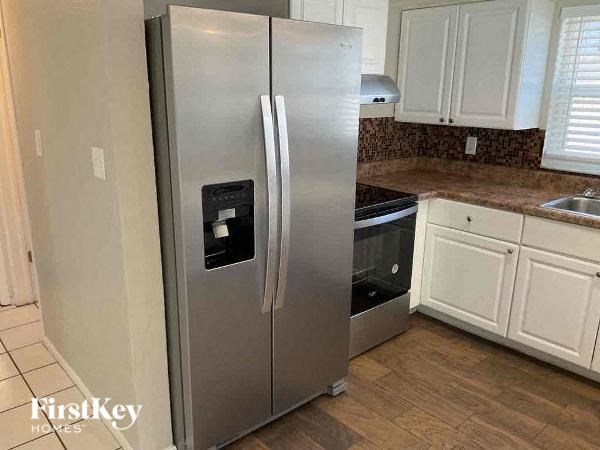 A stainless steel refrigerator with a water and ice dispenser in the door.