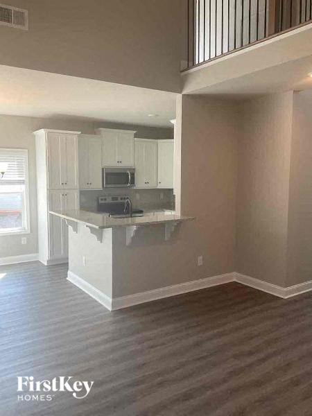 an empty kitchen with an island in the middle