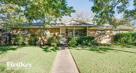 A house with a lawn in front of it.