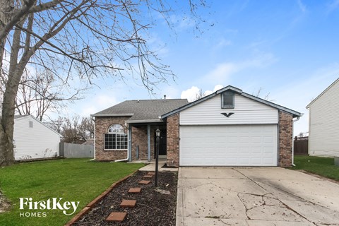 A house with a garage is for sale.