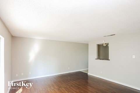 A room with wooden floors and a window.