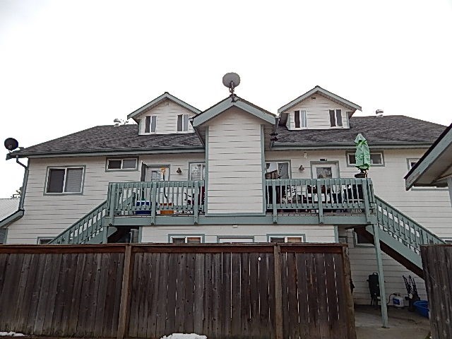 a white house with a balcony and a fence