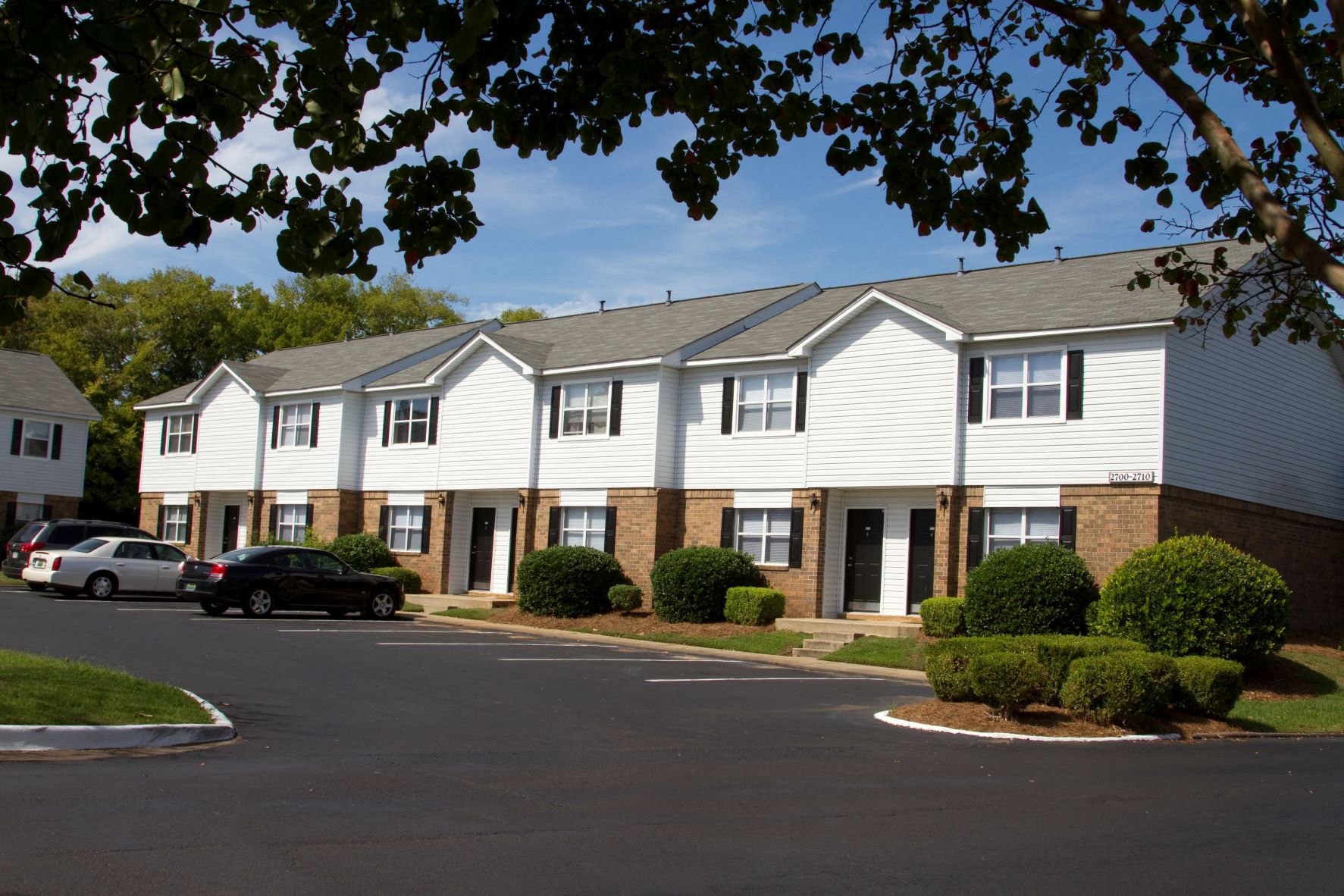 a street view of a building with cars parked in front of it
