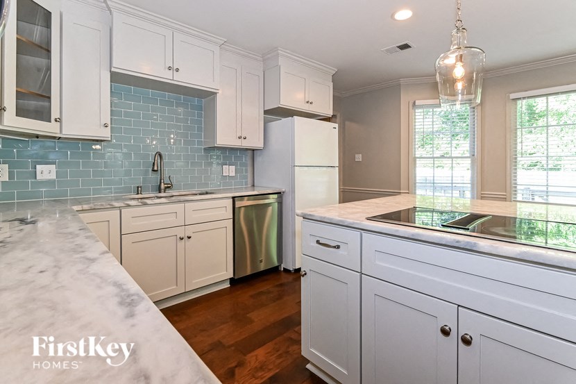a kitchen with white cabinets and a counter top