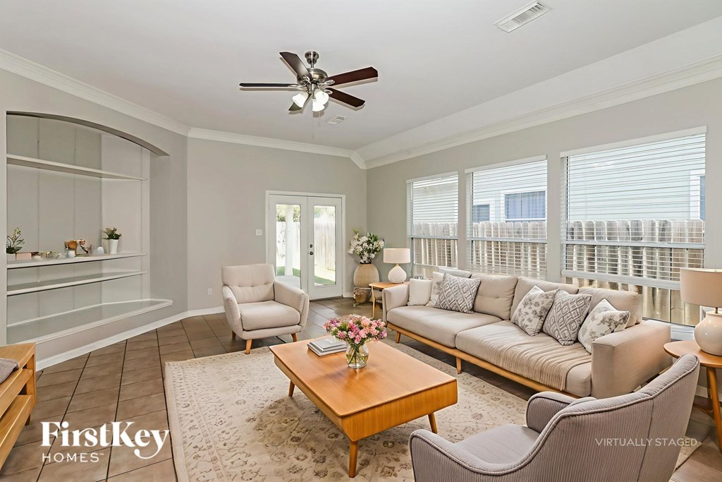 A living room with a couch, chairs, and a coffee table.