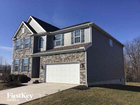 a brick house with a white garage door