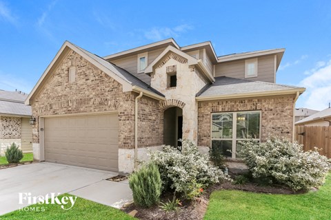 A house with a garage and a driveway.