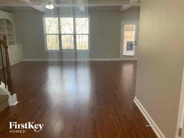 A room with wooden floors and a ceiling fan.