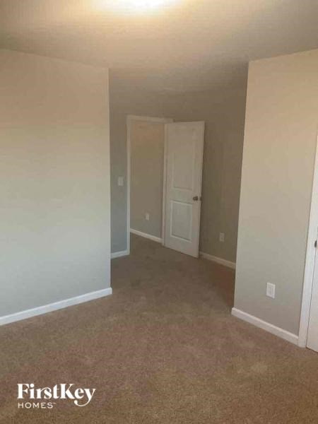an empty room with white walls and a door