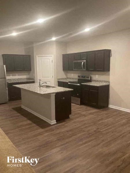a kitchen with stainless steel appliances and black cabinets