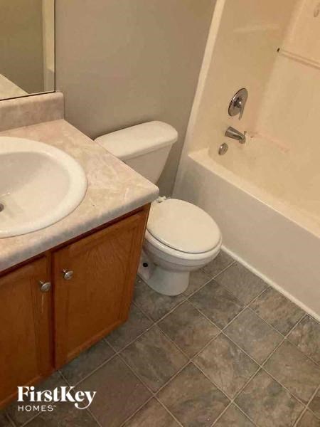 a bathroom with a toilet and a sink and a bath tub