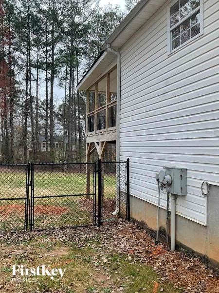 a house with a fence and a balcony on the side of it