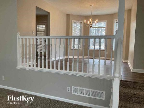 a living room with a white railing